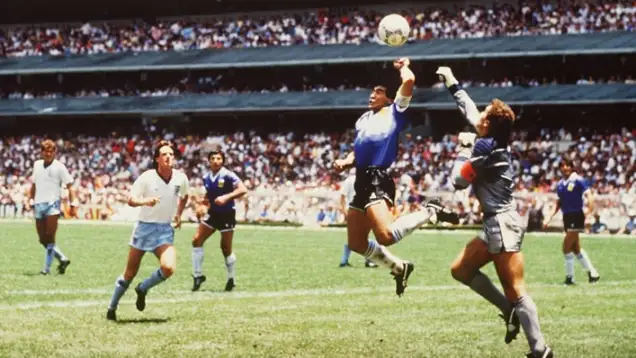 Diego Maradona scores his "Hand of God" goal against England